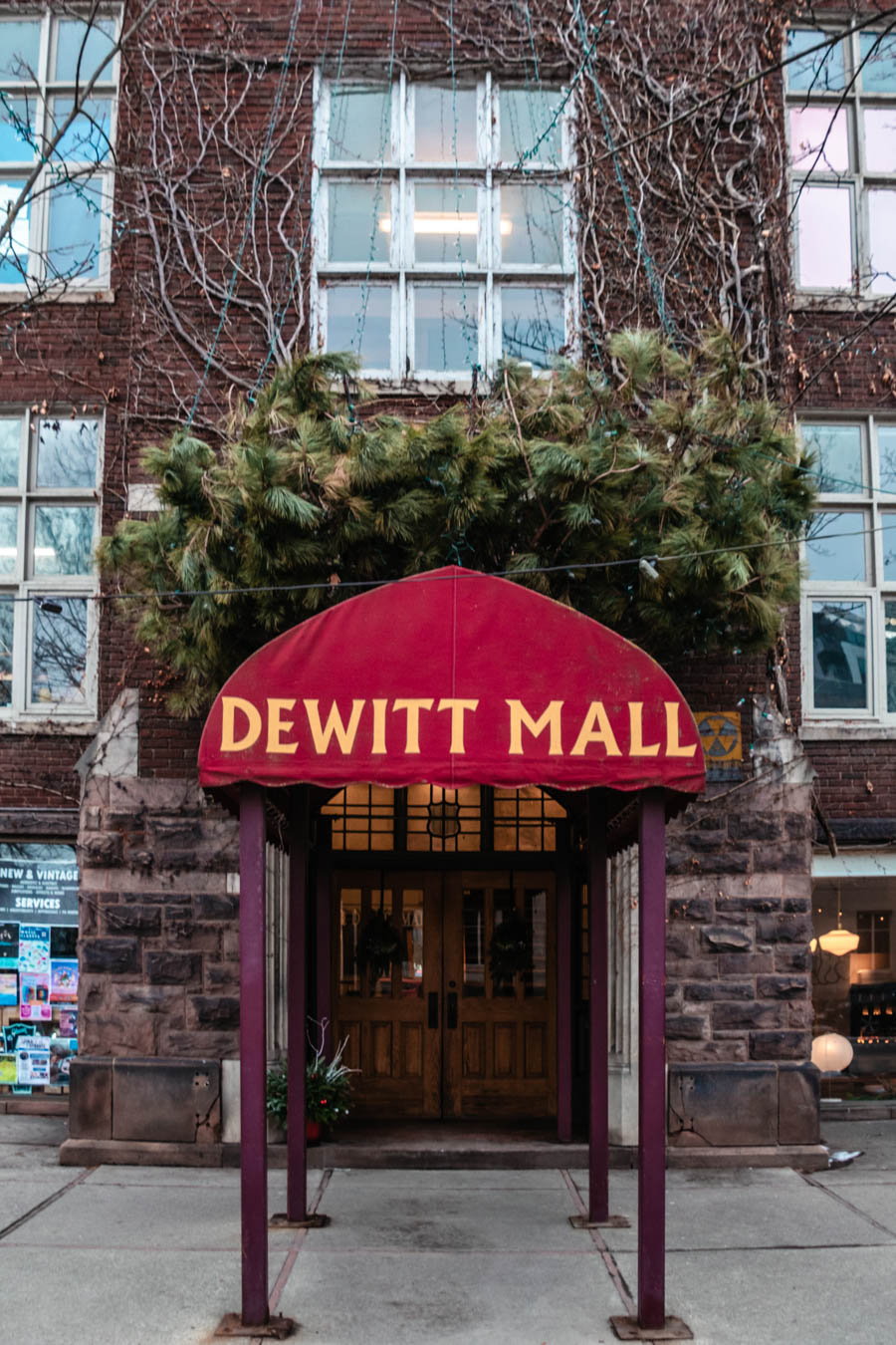 Image of the entrance to DeWitt Mall in Ithaca – The historic DeWitt Mall entrance in downtown Ithaca, featuring a red canopy and ivy-covered brick walls, a charming spot for shopping and dining.