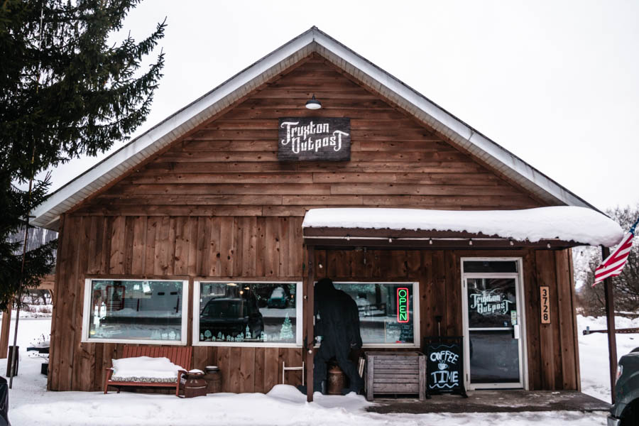 Quaint Wooden General Store - Truxton Outpost– A charming rustic outpost with a wooden facade, offering coffee and winter essentials.